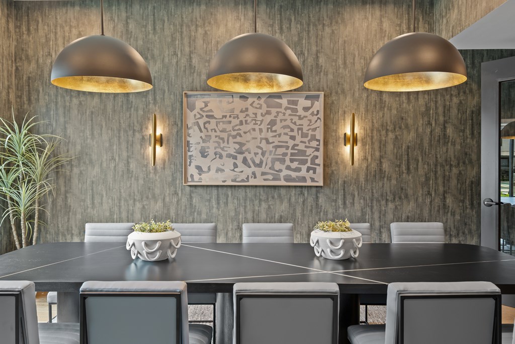 A modern dining room with a large table and chairs.