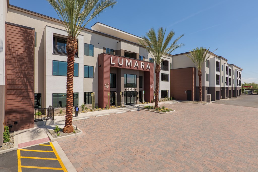 A building with the name Lumara on it is surrounded by palm trees.