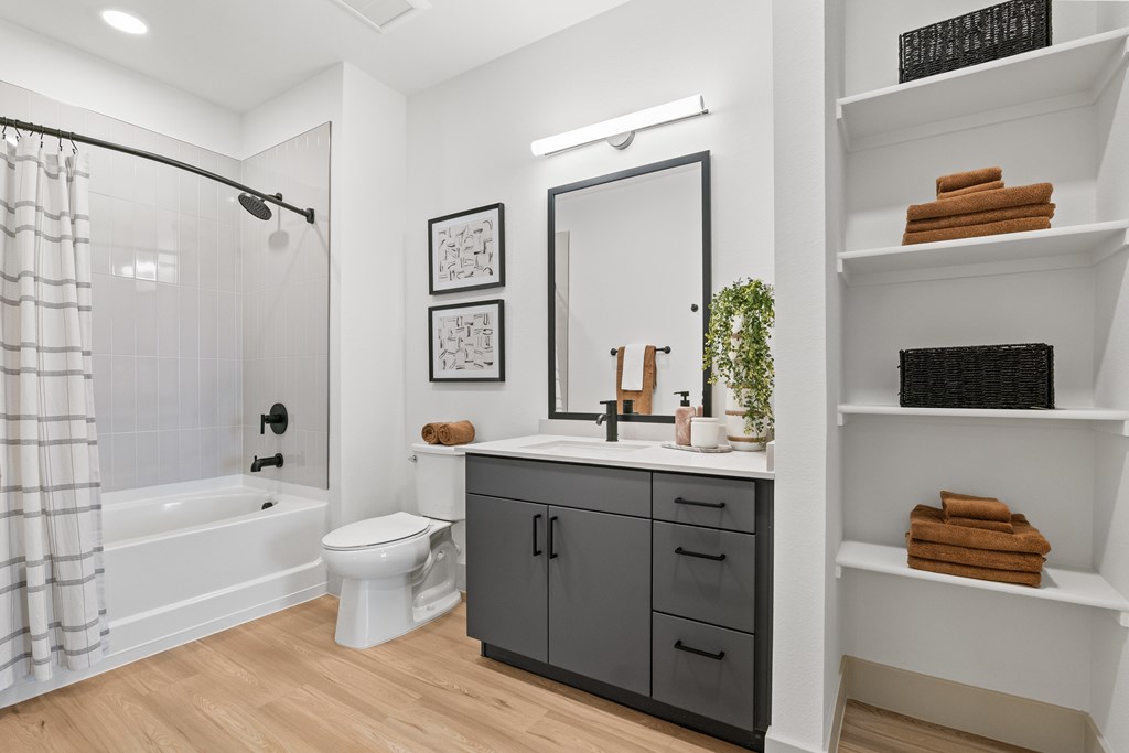 A bathroom with a white tub, toilet, and sink.