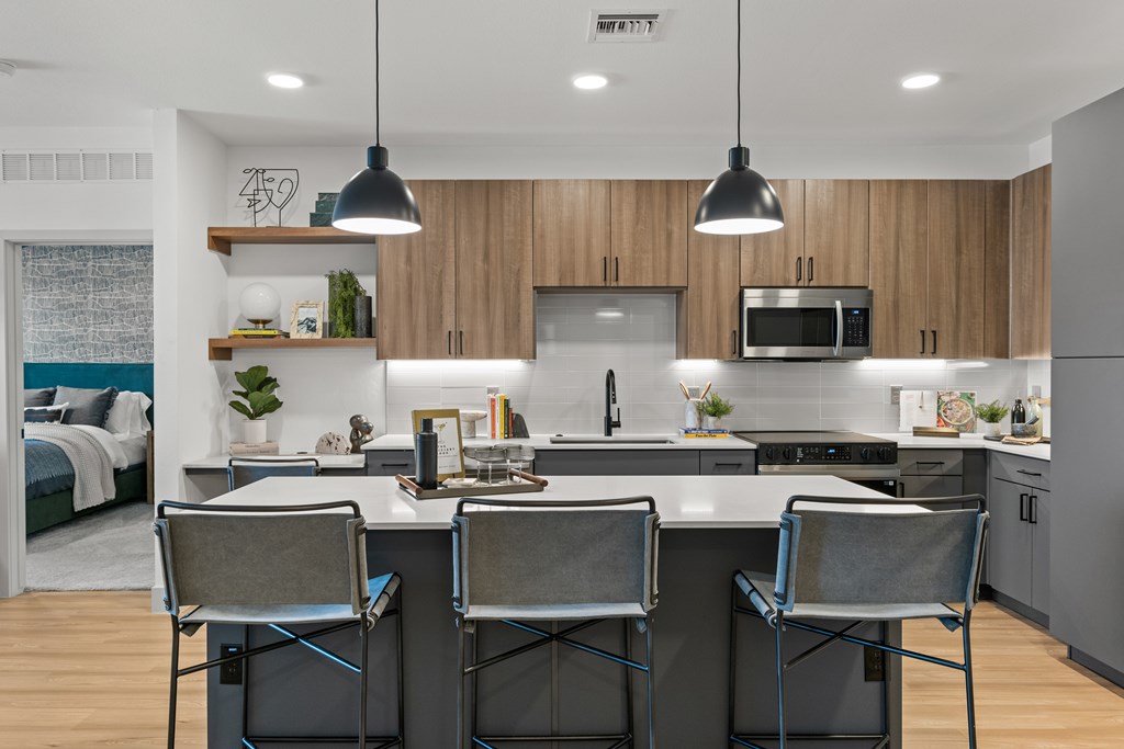 A modern kitchen with a dining table and chairs.
