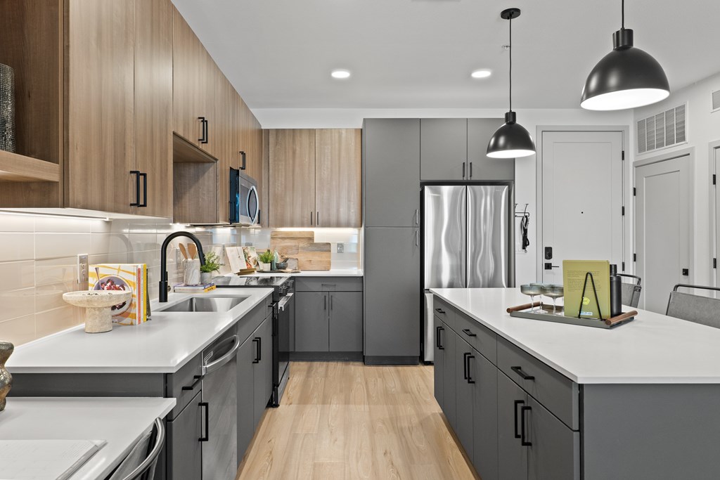 A modern kitchen with wooden cabinets and stainless steel appliances.