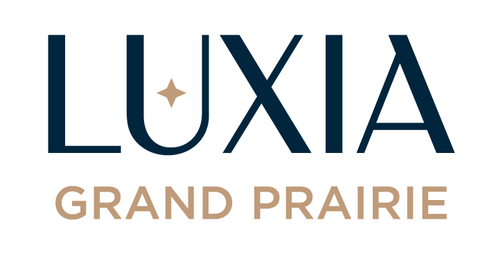 A logo with the word "LUXIA" in dark blue and "GRAND PRAIRIE" in light blue.