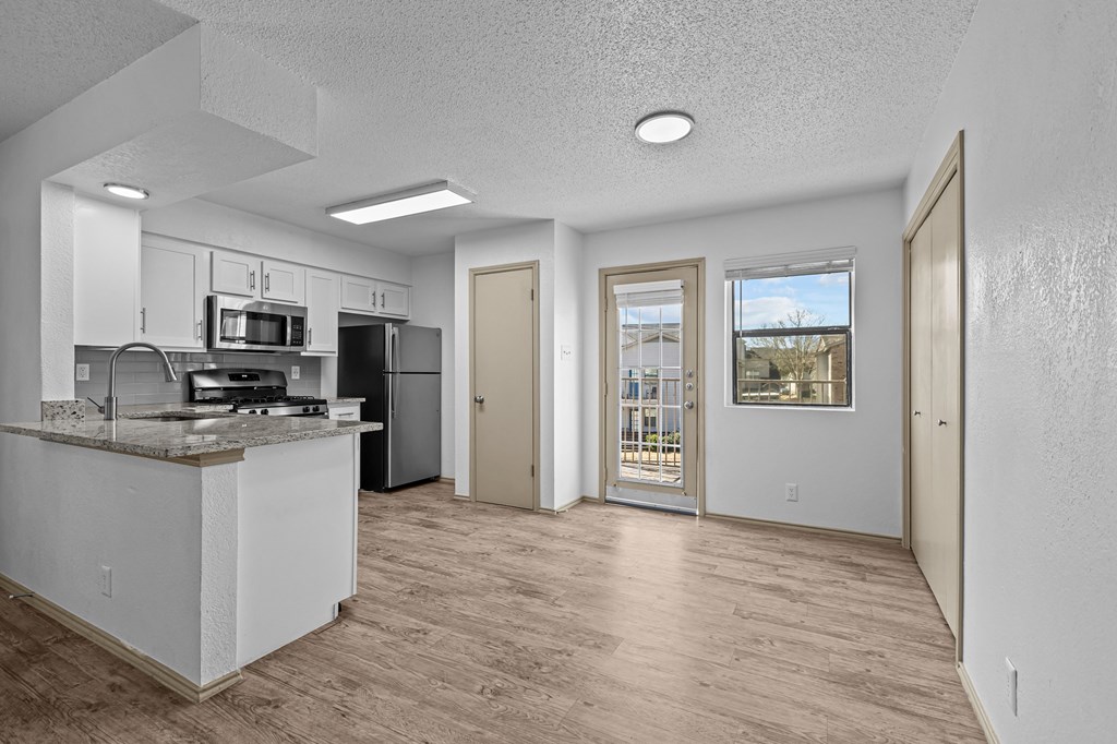 A kitchen with a counter and a fridge.