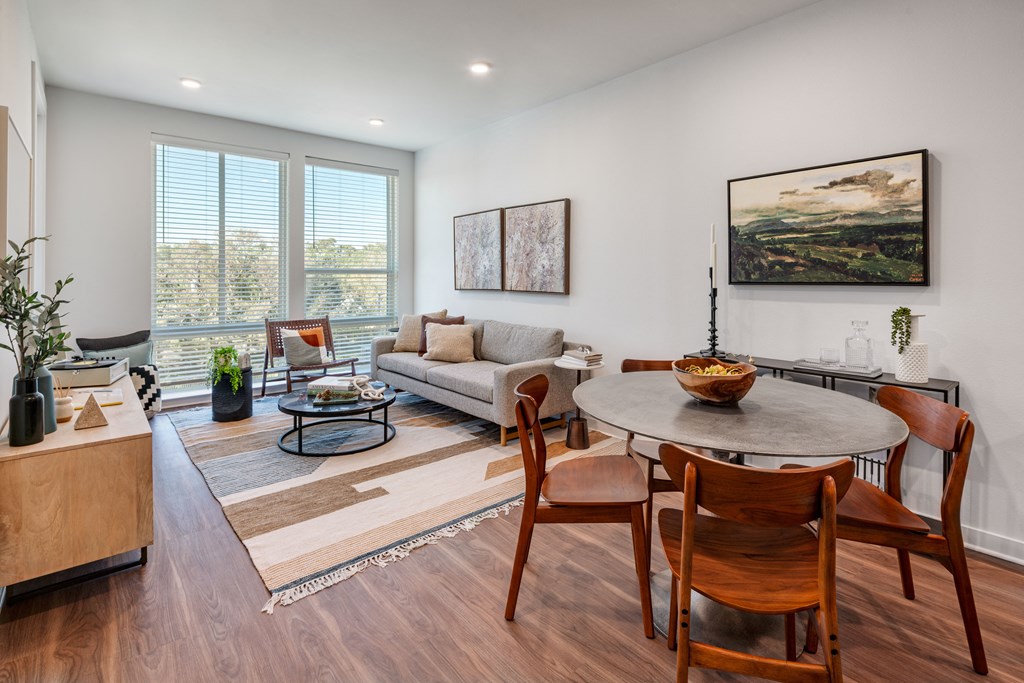 A modern living room with a wooden floor and furniture.