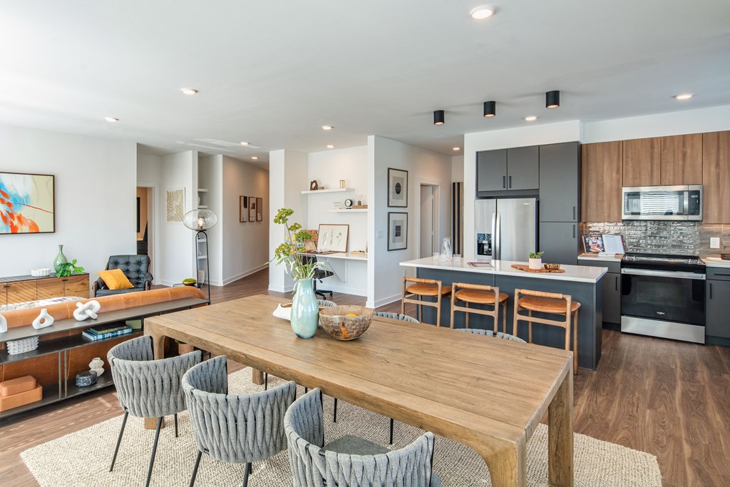 A modern kitchen with a dining table and chairs.