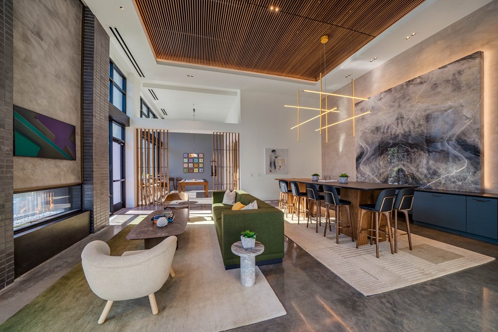 A modern living room with a large painting on the wall.