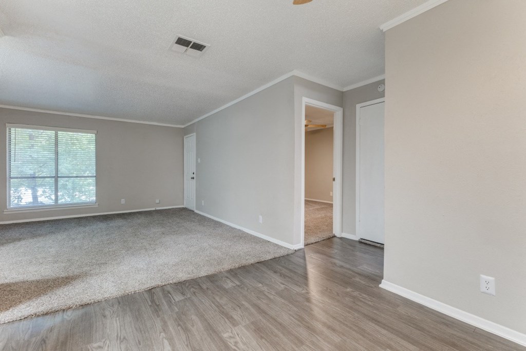 a bedroom with hardwood floors and grey walls