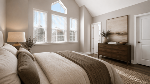 A bedroom with a large bed and a painting on the wall.