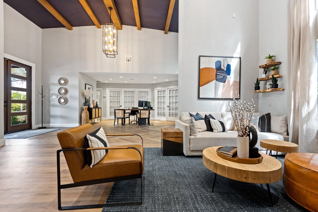 a living room filled with furniture and a large window