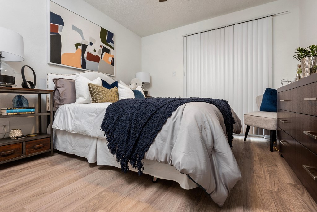 a bedroom with a bed and a dresser