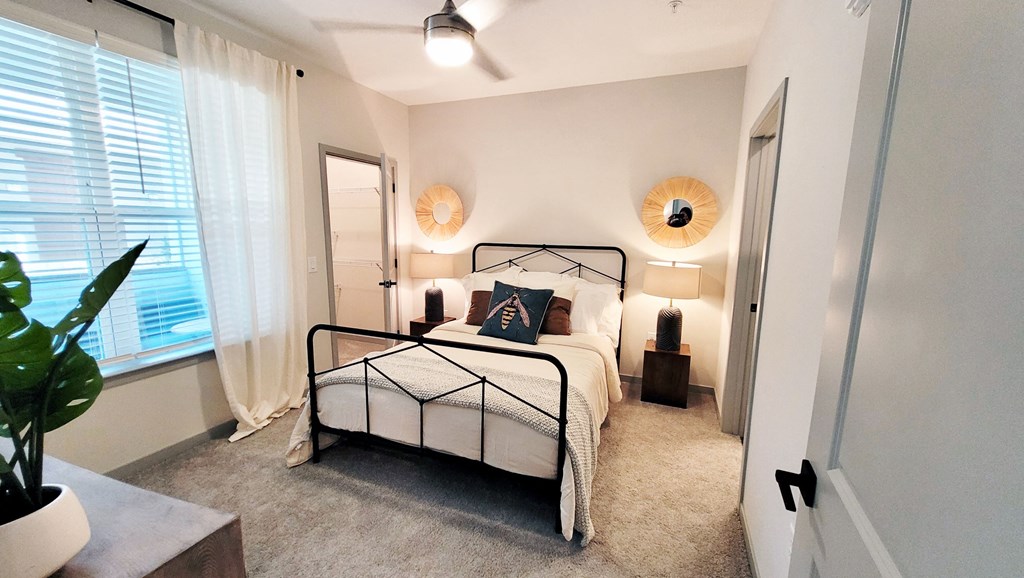 a bedroom with a bed and a window