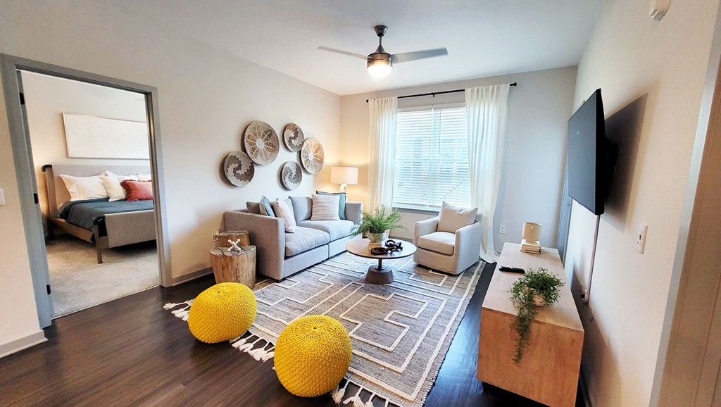 a living room with couches a coffee table and a tv