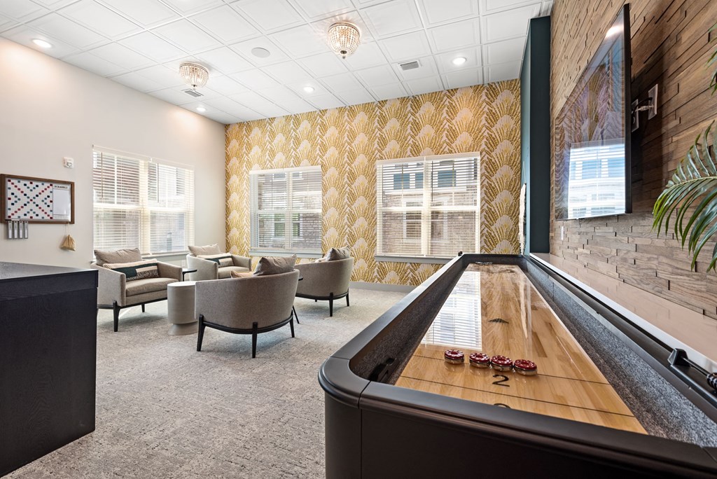 a room with a foosball table and couches