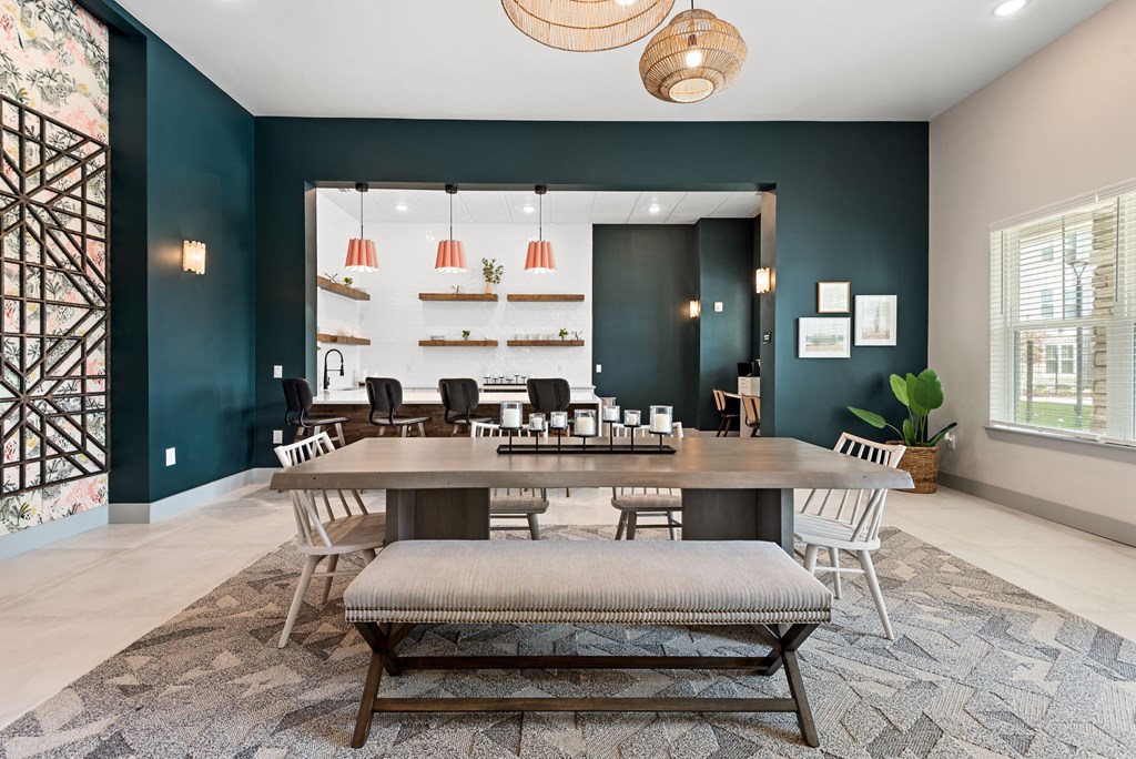 a room with a large table with a bench in the middle of it