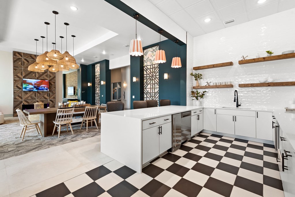 a kitchen with white cabinets and a checkered floor