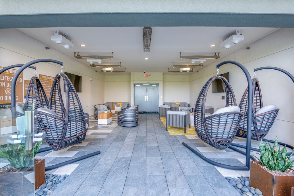 a lobby with hammock chairs and a door