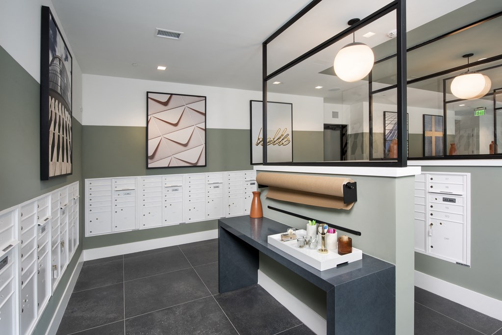 a locker room with a black counter and a row of white lockers