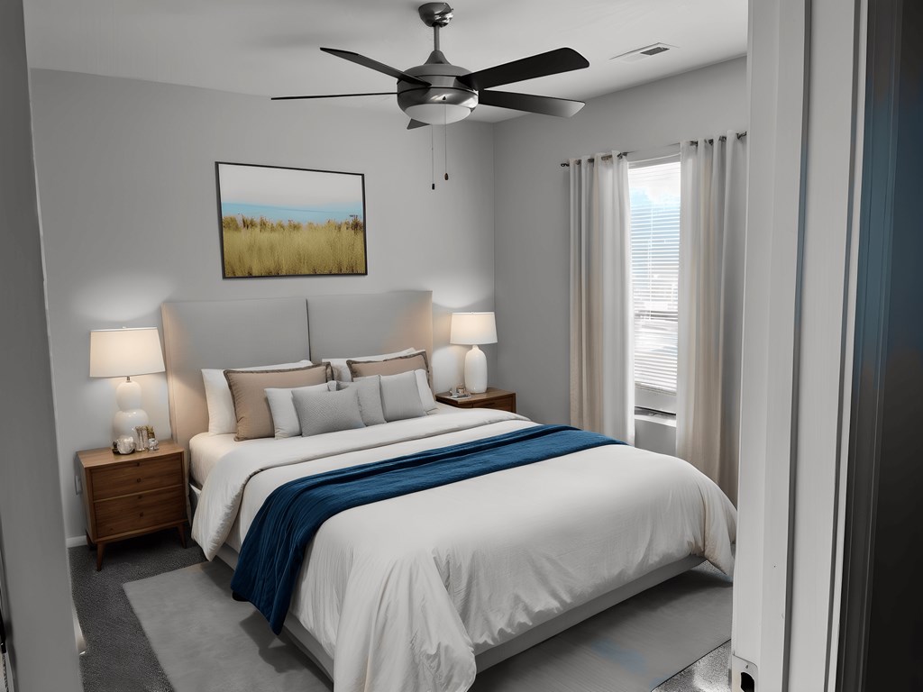 a bedroom with a bed and a ceiling fan