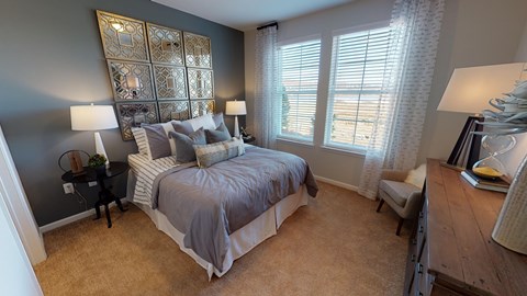 A bedroom with a large bed and a wooden dresser.
