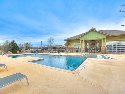 a swimming pool with a building in the background