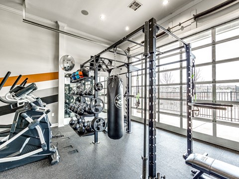 a home gym with a punching bag and weights