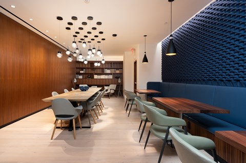 A modern dining area with a long table and chairs.