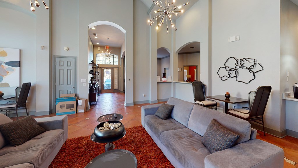 a living room with a large couch and a chandelier