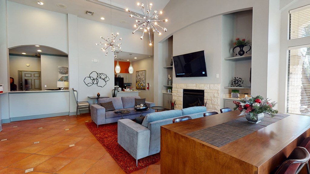a living room with couches and a table and a fireplace