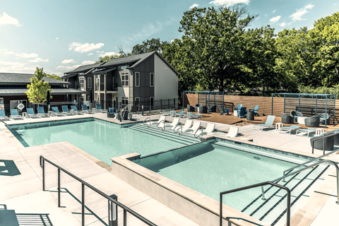 A large outdoor swimming pool with a metal railing.
