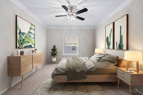A bedroom with a bed, nightstand, and a ceiling fan.
