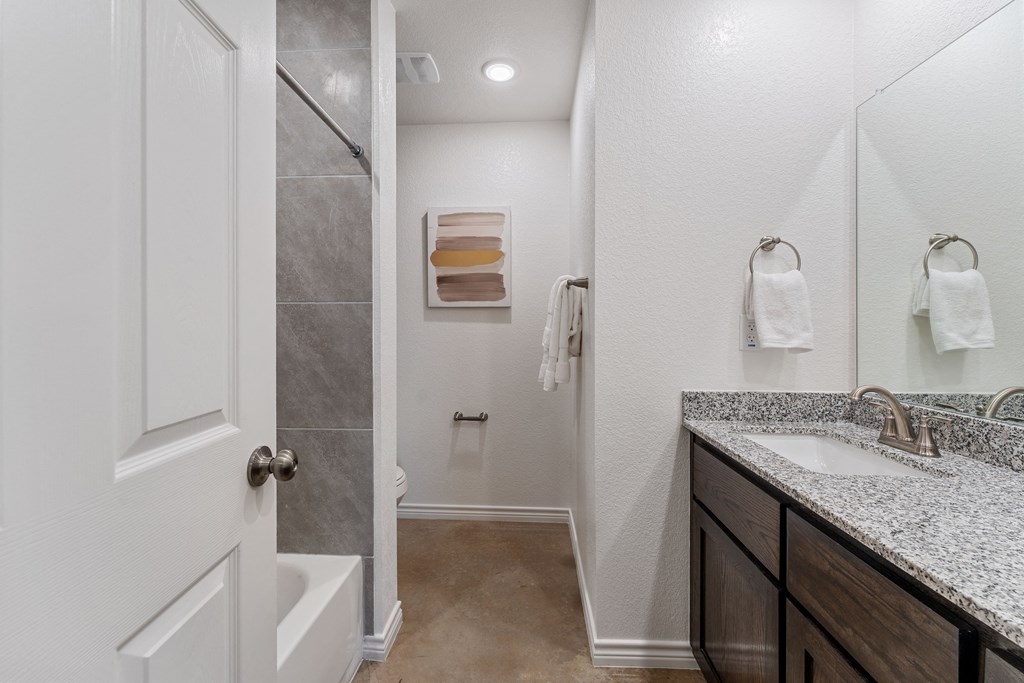 a bathroom with a shower and a sink and a mirror