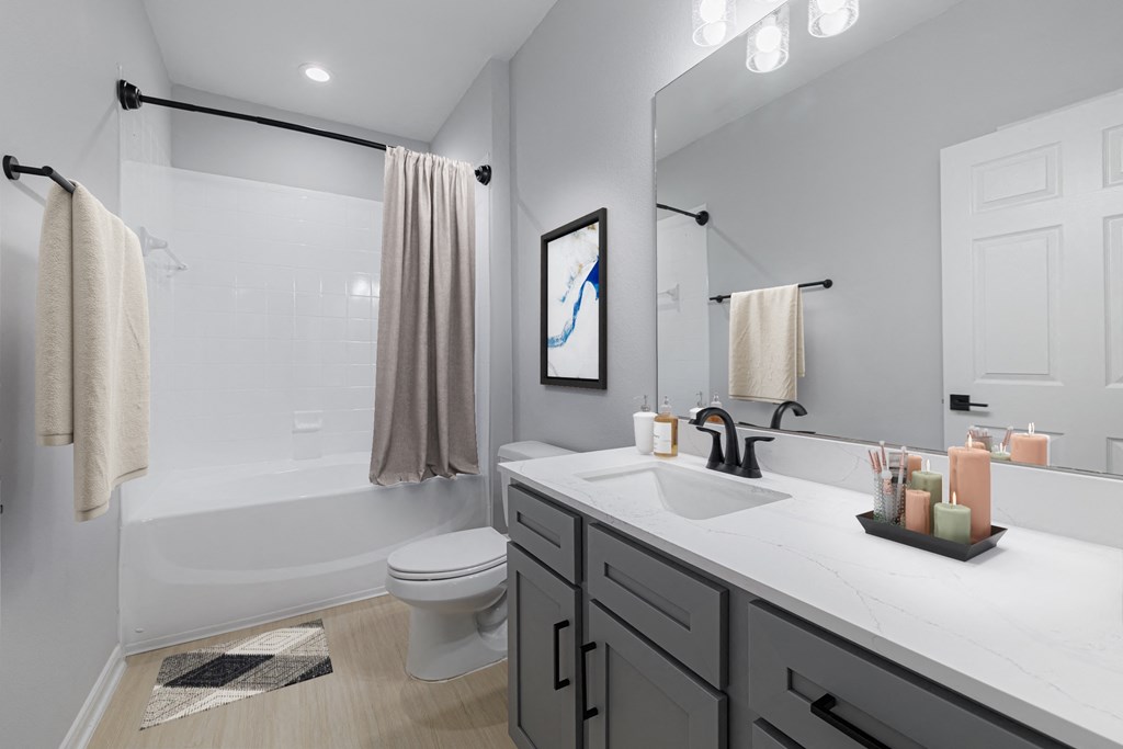 a bathroom with a shower and a sink and a toilet