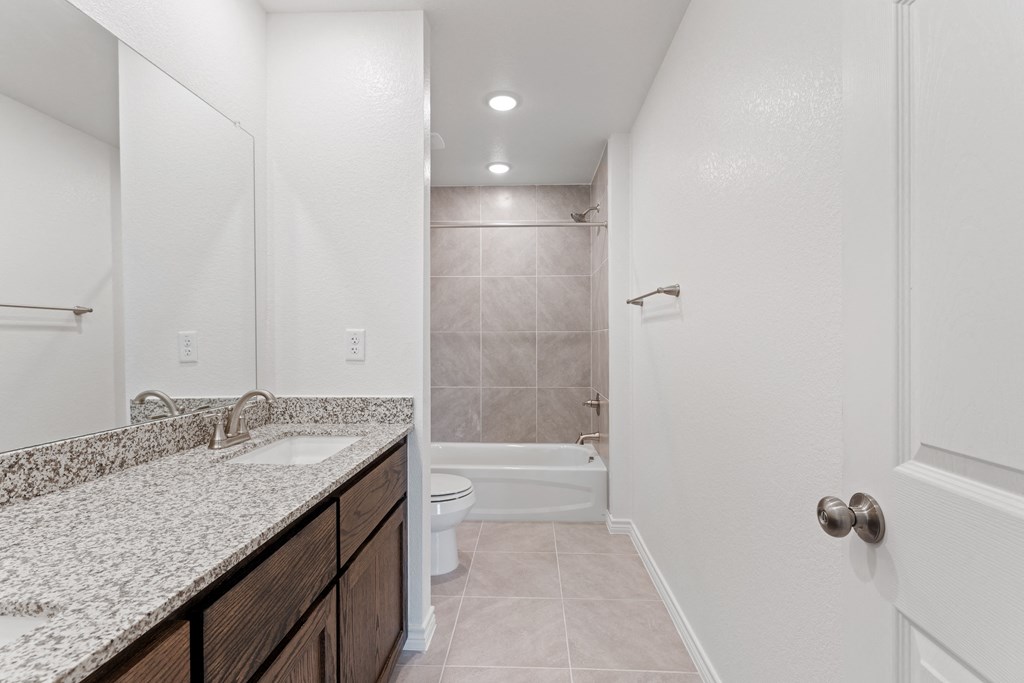a bathroom with a sink and a toilet and a shower