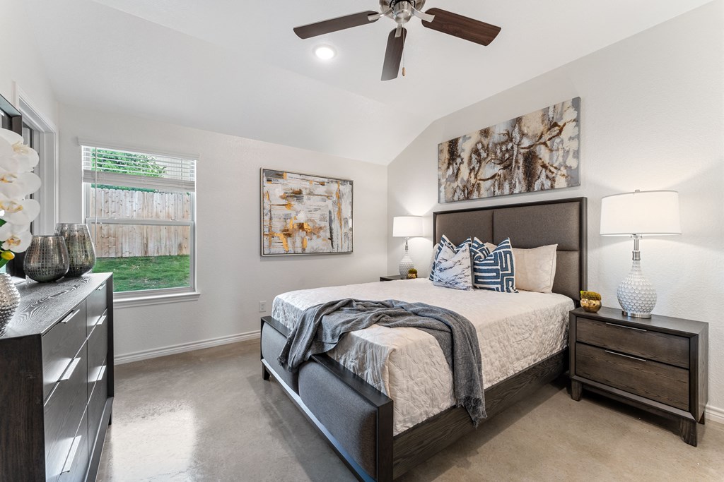 the master bedroom in a new home with a ceiling fan