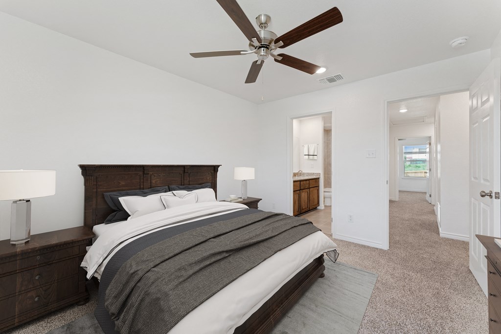 a large bedroom with a bed and a ceiling fan