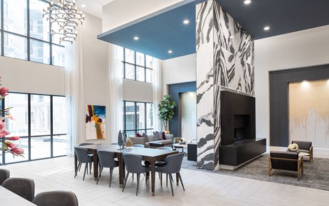 A modern living room with a fireplace and a dining table.