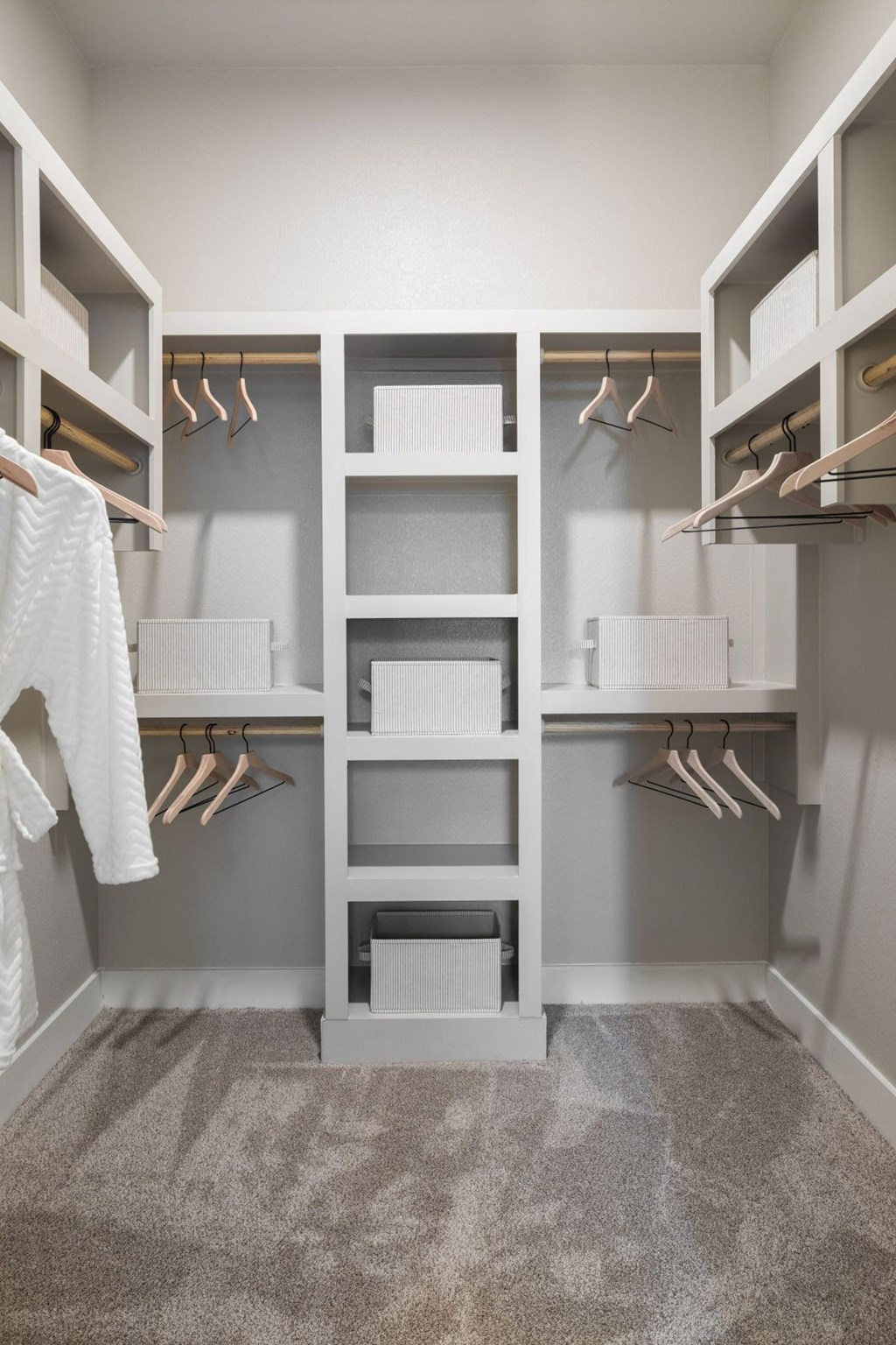a walk in closet with shelves and hangers