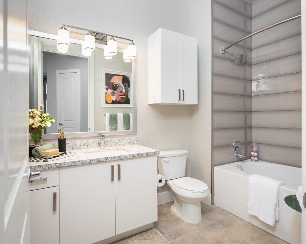 a bathroom with a toilet and a sink and a mirror