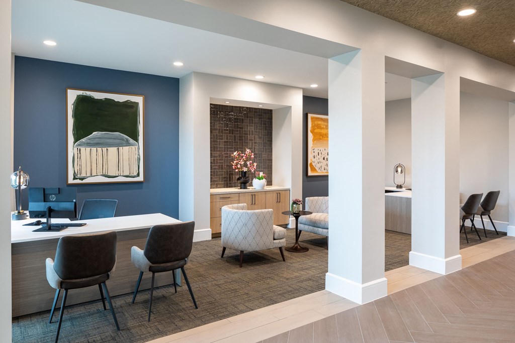 a conference room with blue walls and a white table and chairs