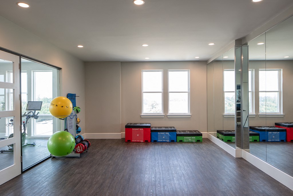 an empty living room with crates and a green ball on the floor