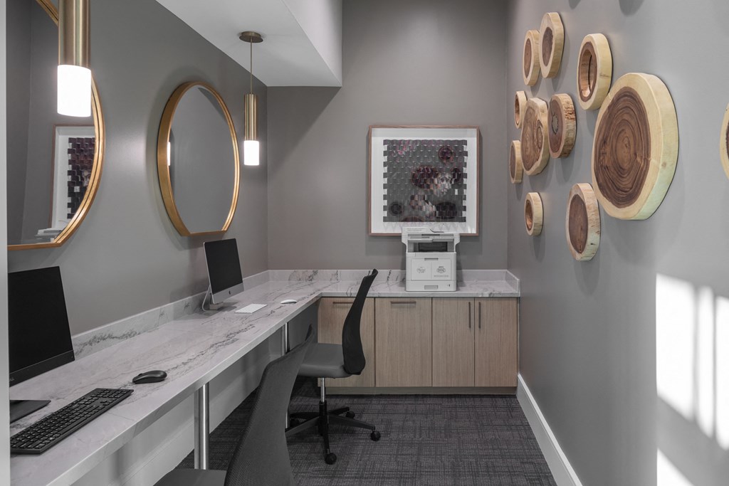 a desk with a computer and a monitor in a room