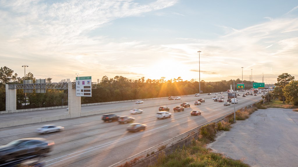 a busy highway with cars on it at sunset