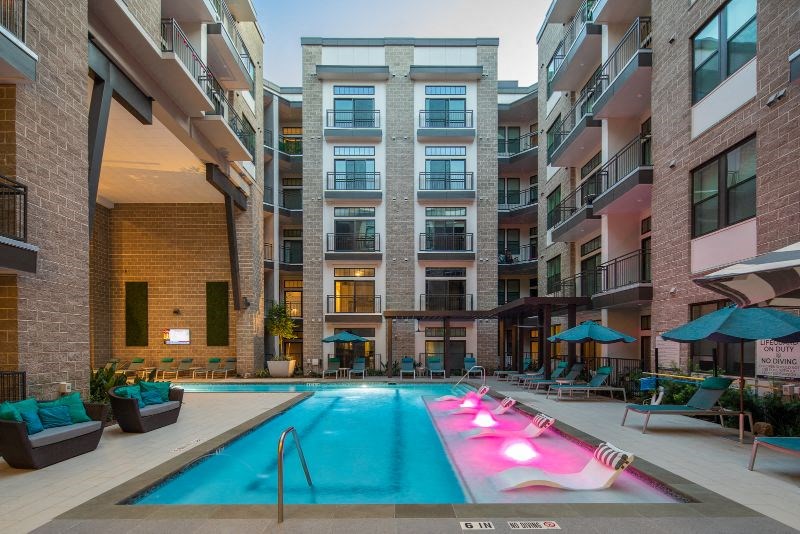a swimming pool in the middle of an apartment building