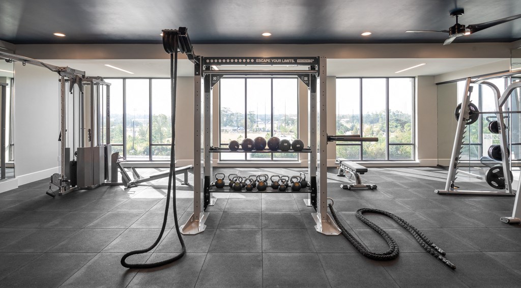 a home gym with weights and equipment and windows
