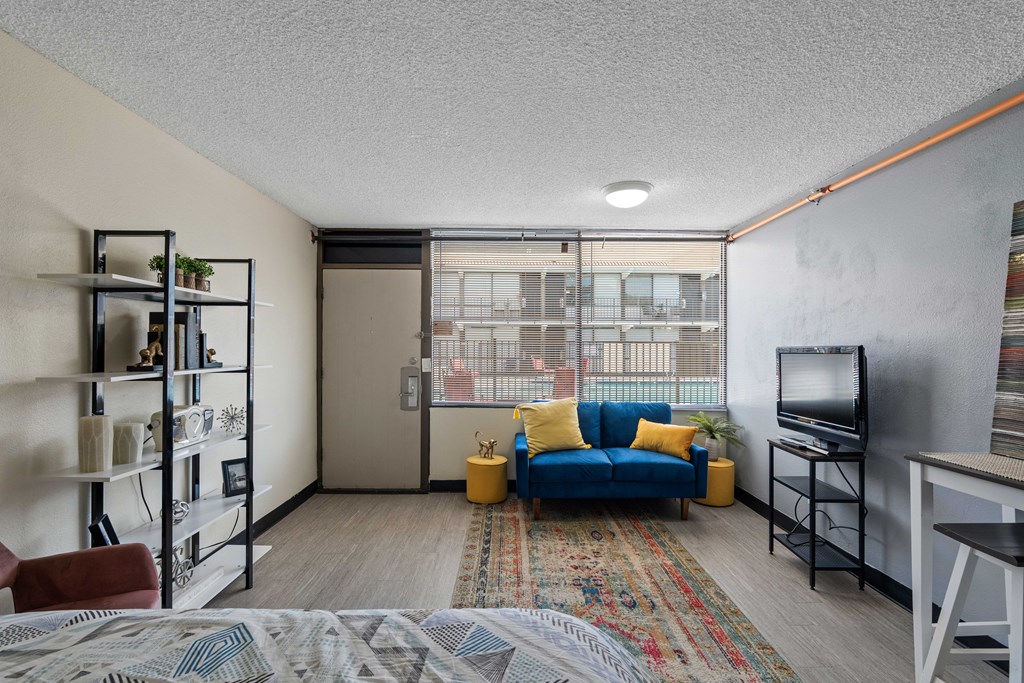 A living room with a blue couch and a television.