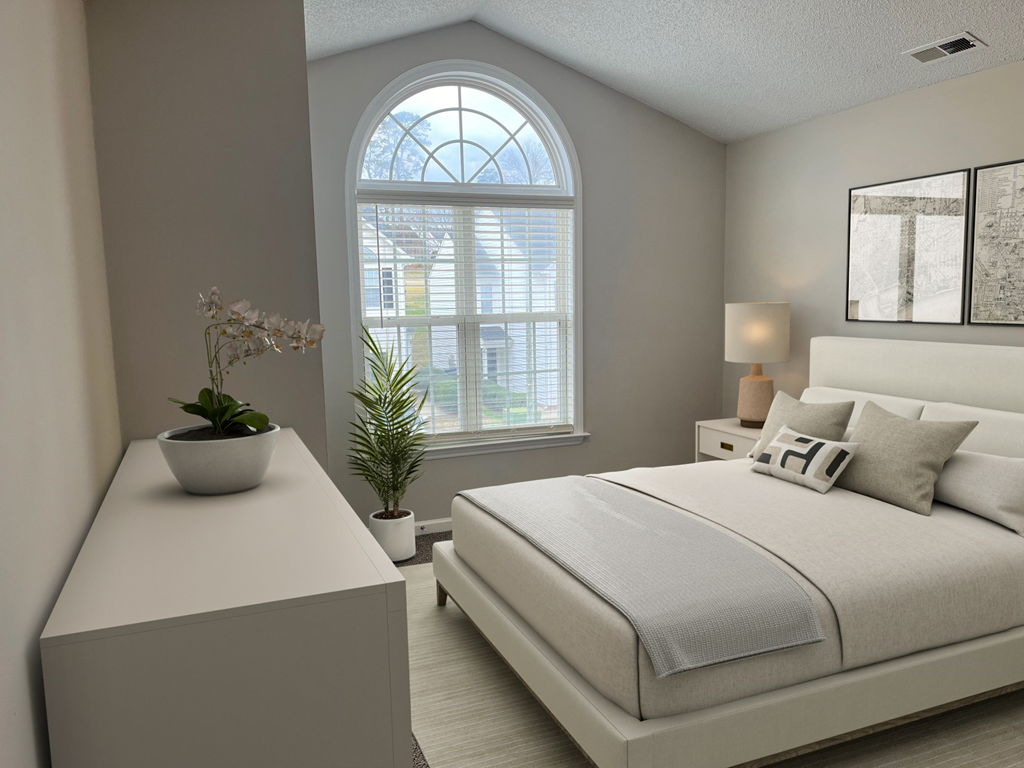 a bedroom with a bed and a dresser and a window