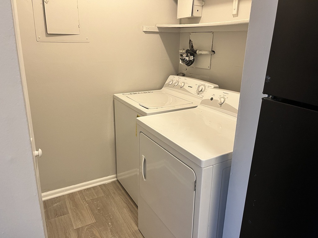 a white washer and dryer in a small room with a sink and refrigerator