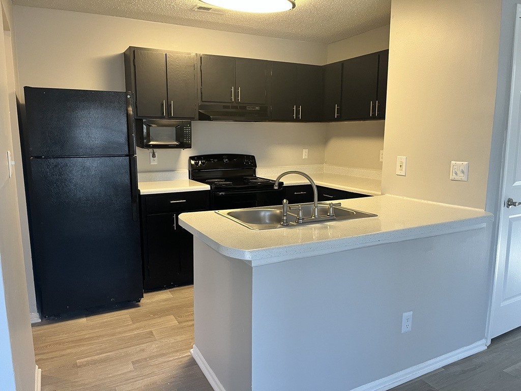 a kitchen with a sink and a refrigerator