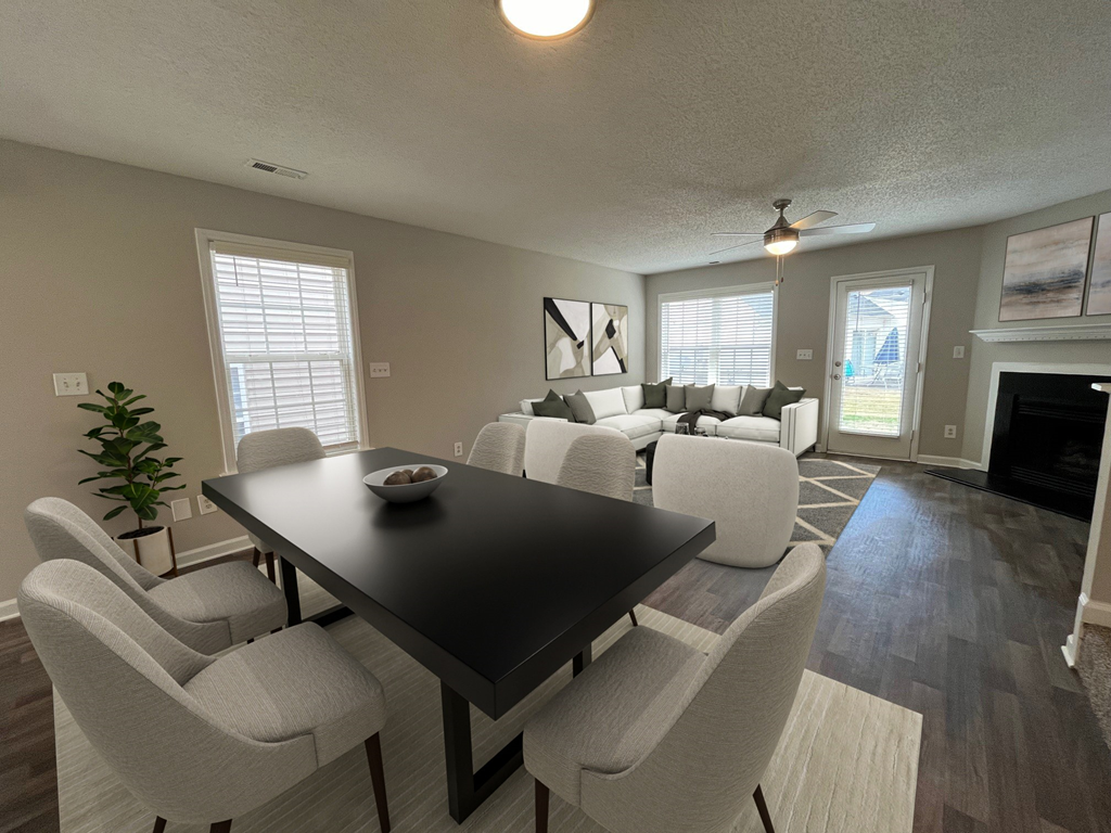 a living room and dining room with white chairs and a black table