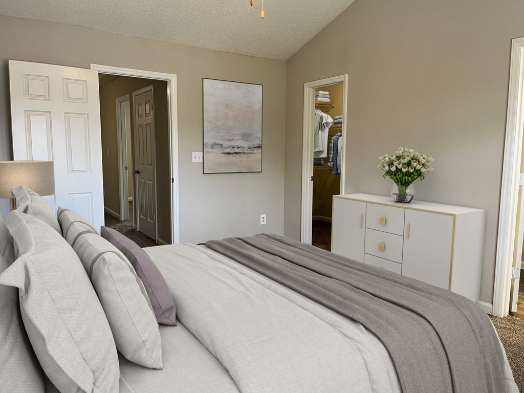 a bedroom with a bed and a dresser and a closet